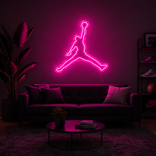 Neon jump man logo on a dark wall in a living room setting.