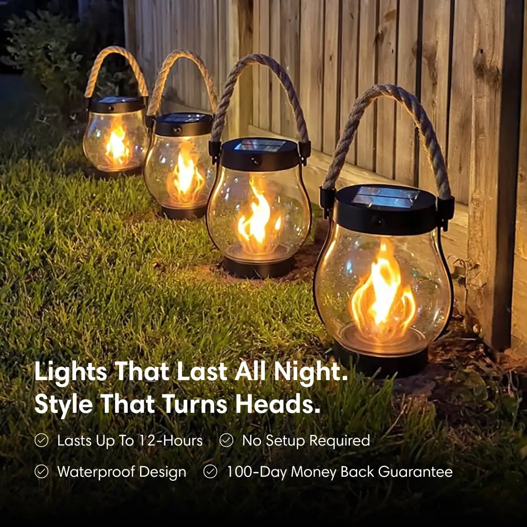 Solar-powered outdoor lanterns with flames on a grassy area.